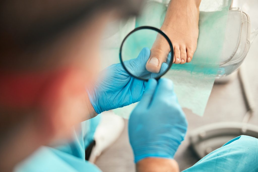 Attentive medical worker checking nail after procedure